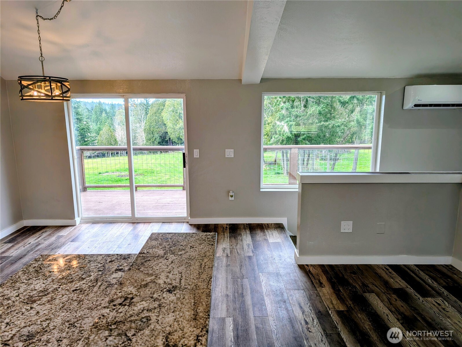11108 Bliss Cochrane Road Northwest Gig Harbor, WA 98329 - Photo 12 of 39 a living room with a large window