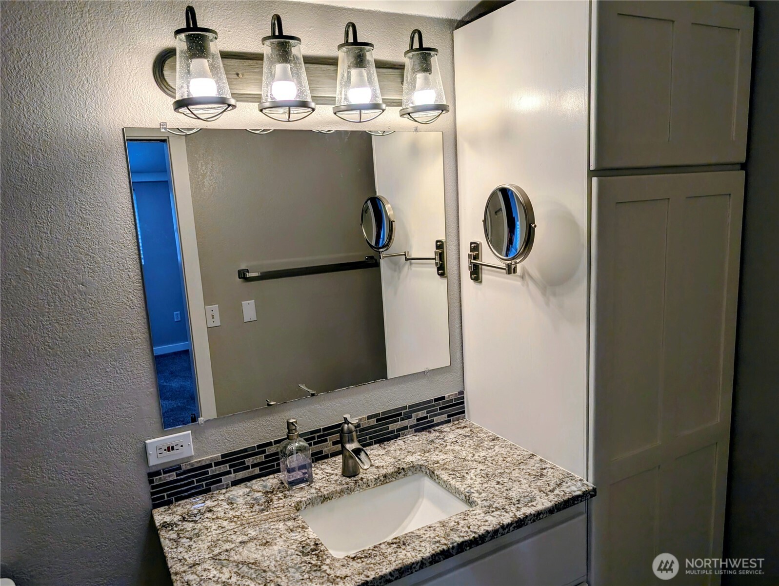 11108 Bliss Cochrane Road Northwest Gig Harbor, WA 98329 - Photo 19 of 39 a bathroom with a granite countertop sink and a mirror