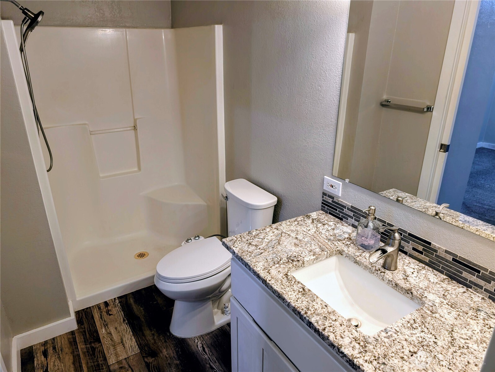 11108 Bliss Cochrane Road Northwest Gig Harbor, WA 98329 - Photo 20 of 39 a bathroom with a granite countertop sink toilet and a mirror