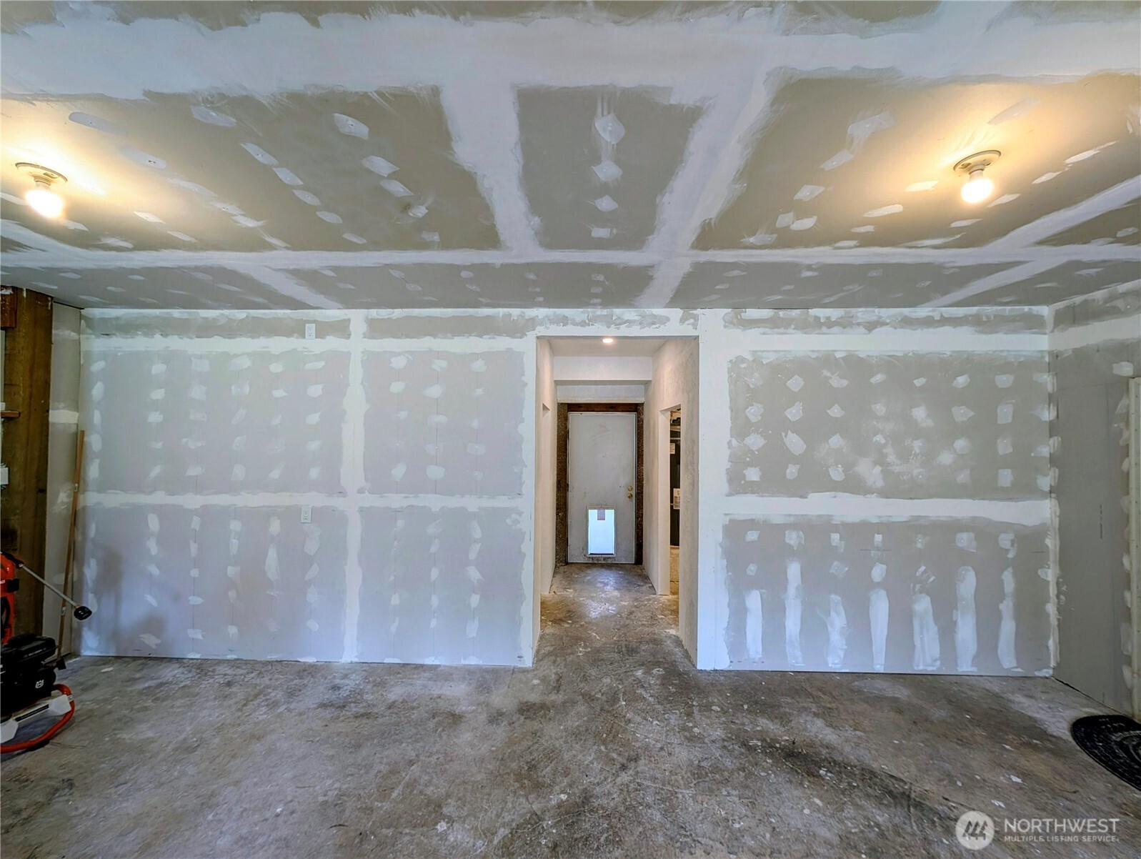 11108 Bliss Cochrane Road Northwest Gig Harbor, WA 98329 - Photo 25 of 39 a view of a hallway with wooden shelves