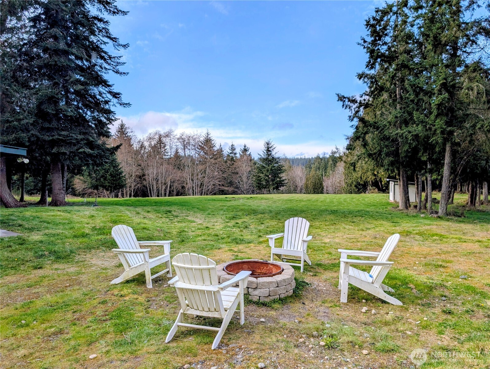 11108 Bliss Cochrane Road Northwest Gig Harbor, WA 98329 - Photo 10 of 39 a view of a table and chairs in the garden