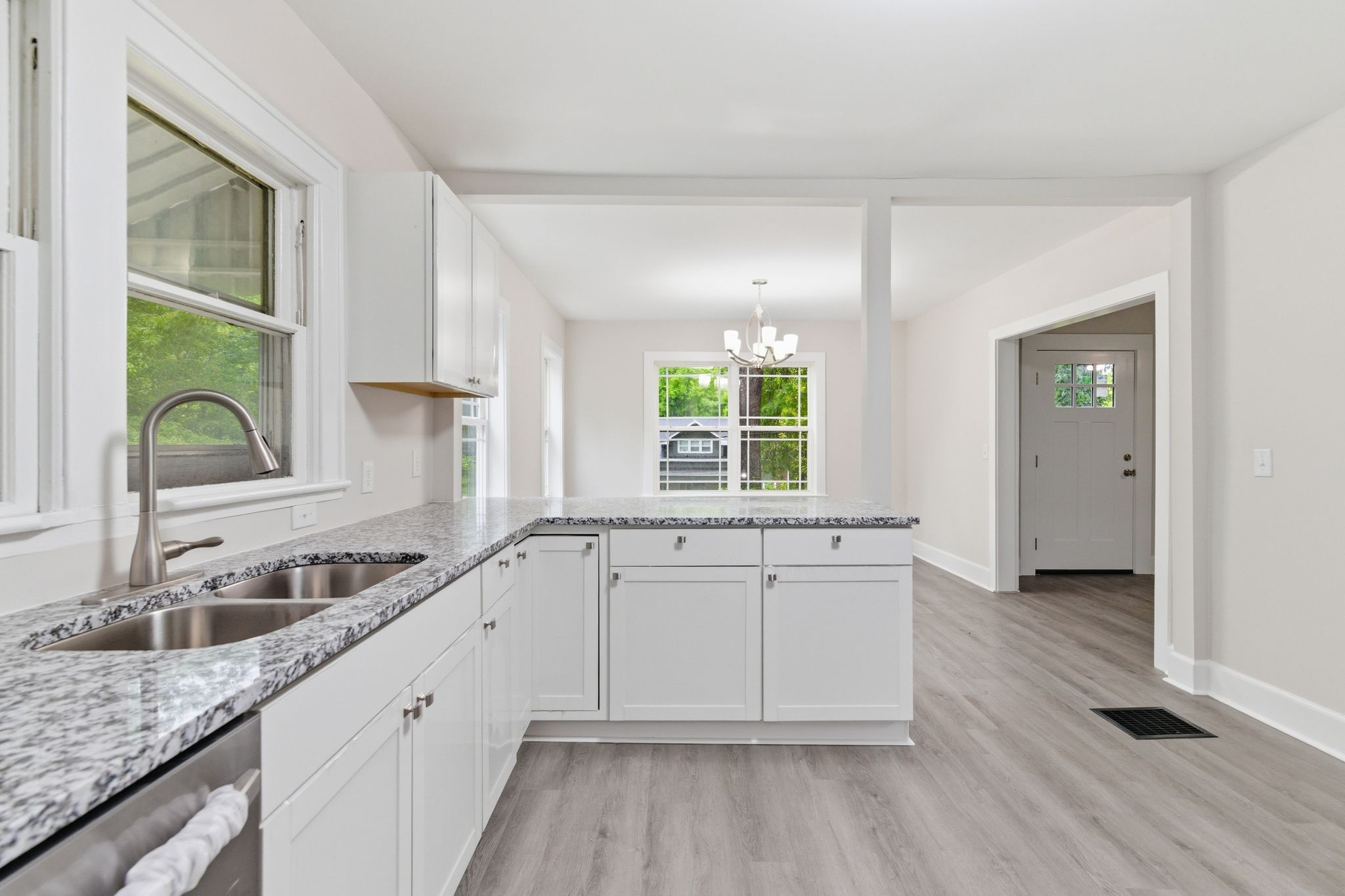 305 South Irwin Street Manchester, TN 37355 - Photo 15 of 40 a kitchen with granite countertop white cabinets and a sink