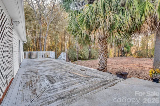 a view of a house with a yard and wooden fence