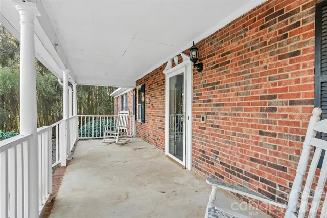 a view of a porch with a floor to ceiling window