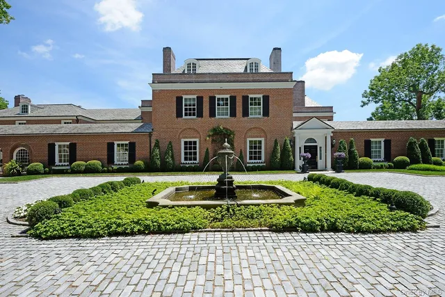 a dining room with furniture a chandelier and wooden floor