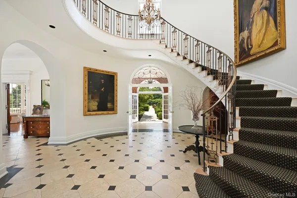 a living room with furniture a fireplace and a large window