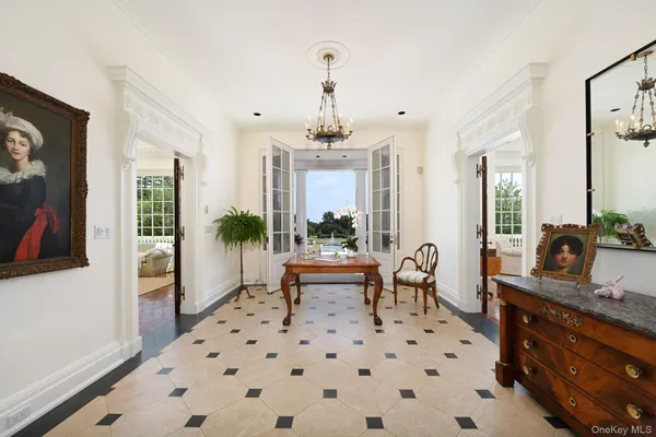 a living room with furniture a fireplace flat screen tv and windows