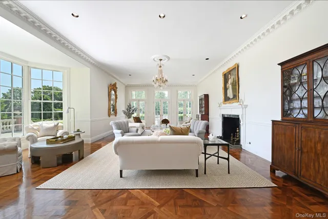 a living room with fireplace furniture and a floor to ceiling window