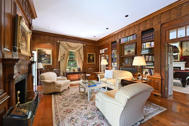 a living room with furniture a flat screen tv and a large window
