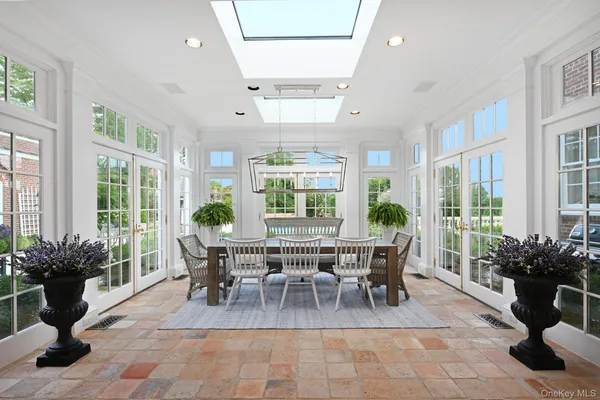 a view of a roof deck with couches and wooden floor