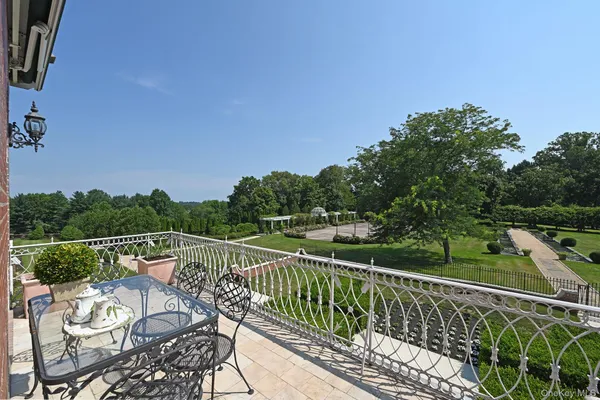 an aerial view of a house with swimming pool and furniture