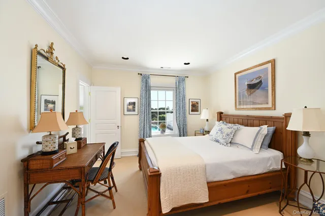 a view of a small house with a small yard and a large tree