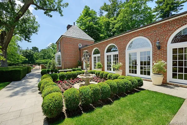 a view of a house with potted plants