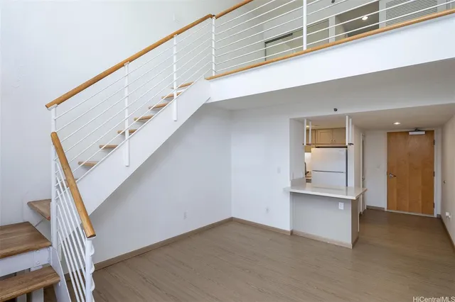 a view of entryway and hall with wooden floor