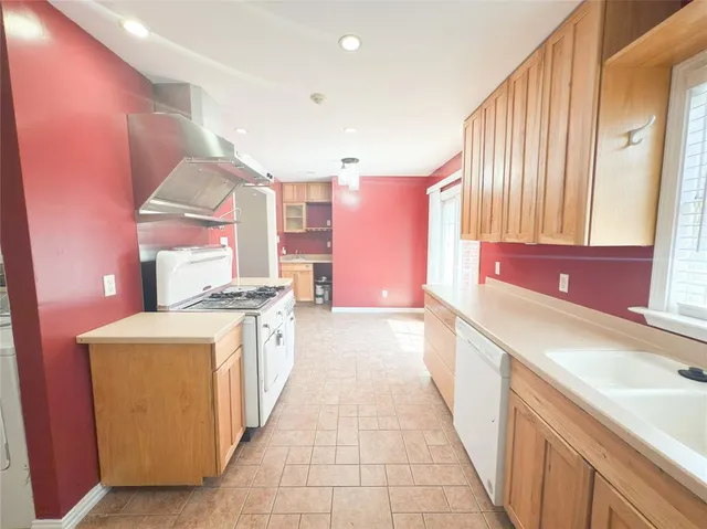 a kitchen with stainless steel appliances a sink and a stove