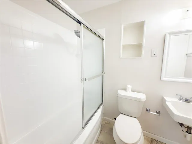 a bathroom with a sink toilet and a mirror