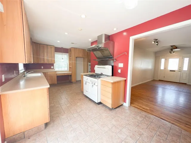 a kitchen with a sink and a stove top oven