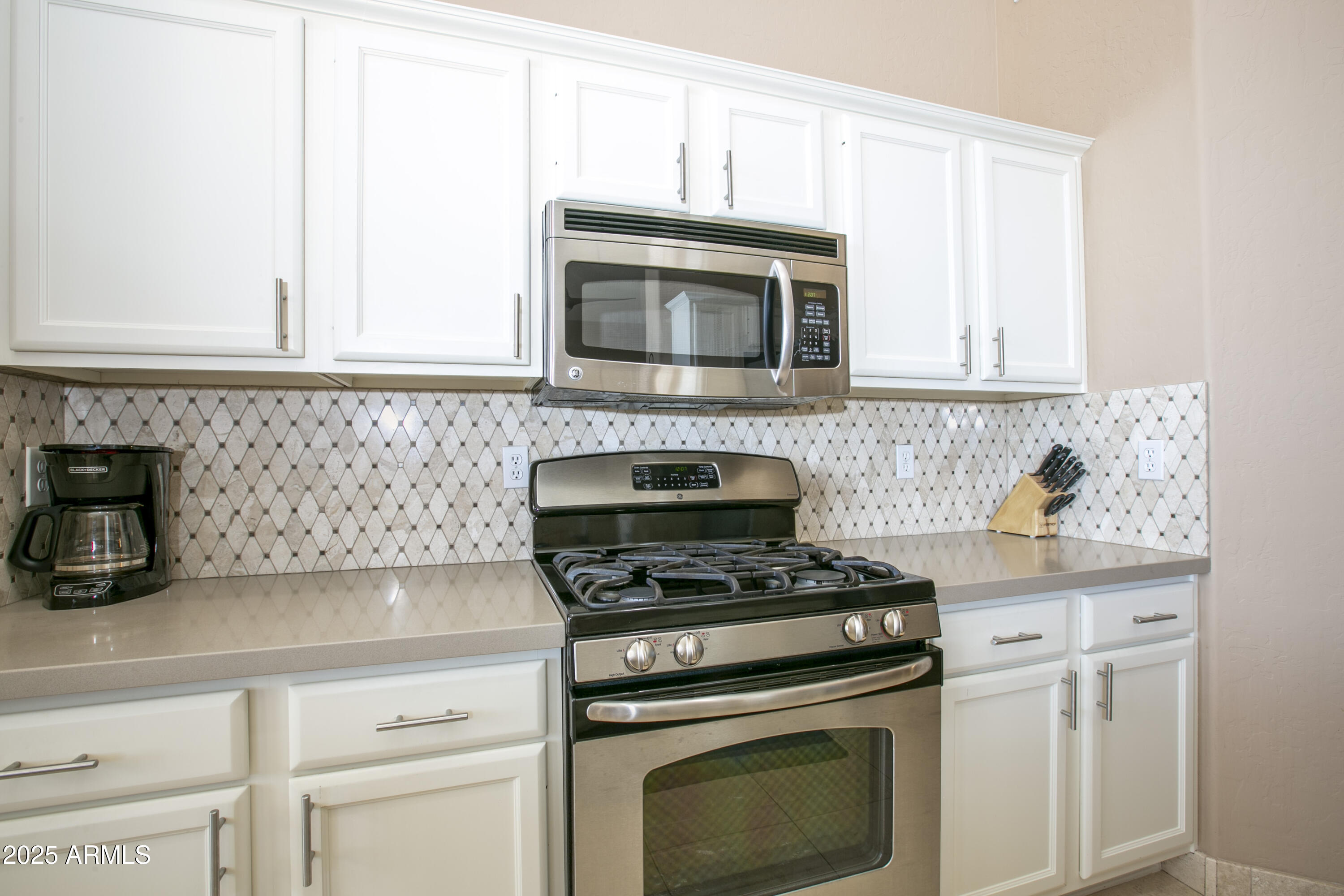3055 North Red Mountain, Unit 156 Mesa, AZ 85207 - Photo 14 of 33 a kitchen with cabinets and steel stainless steel appliances
