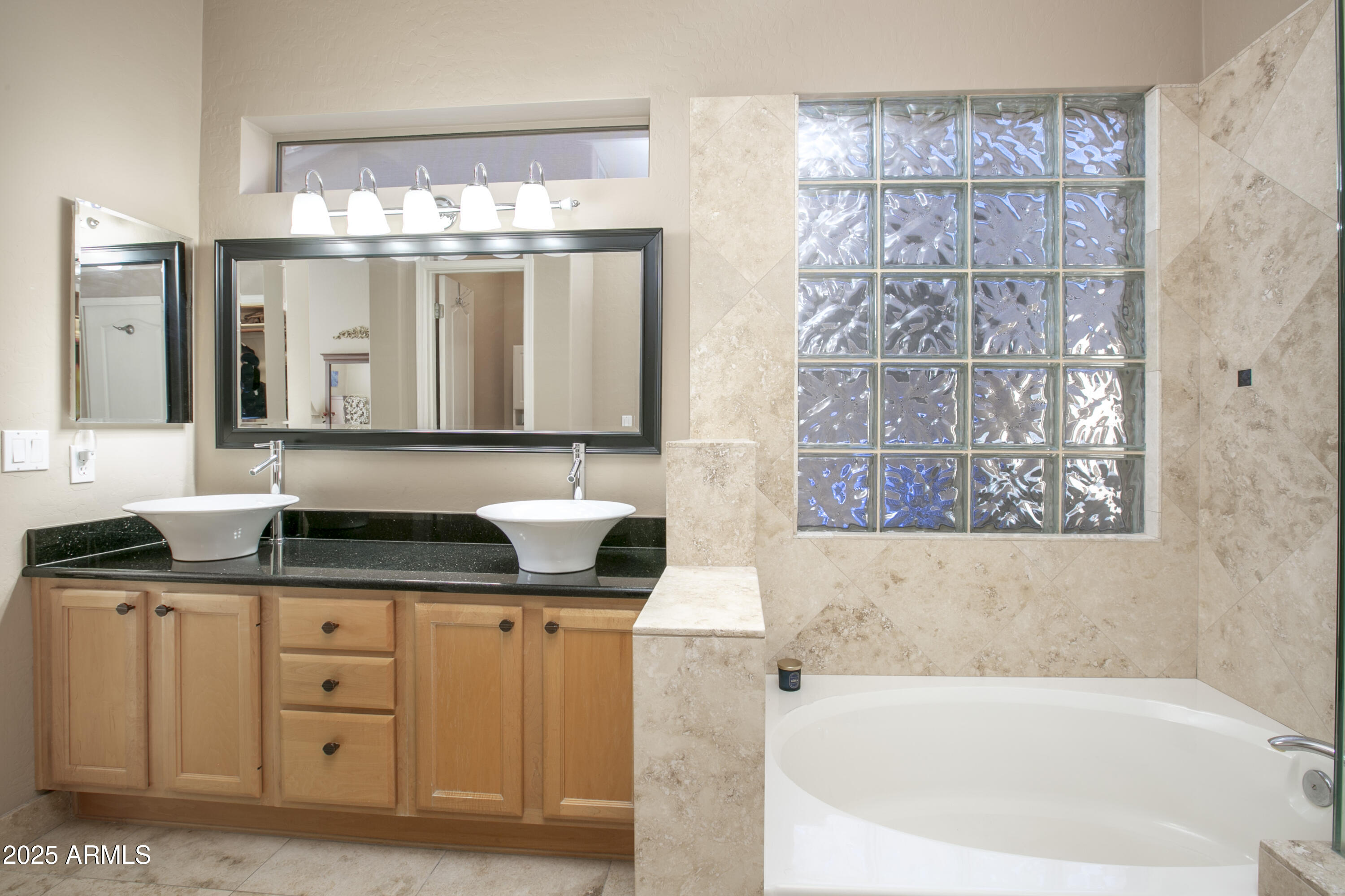 3055 North Red Mountain, Unit 156 Mesa, AZ 85207 - Photo 19 of 33 a bathroom with a granite countertop sink a large mirror and a bathtub
