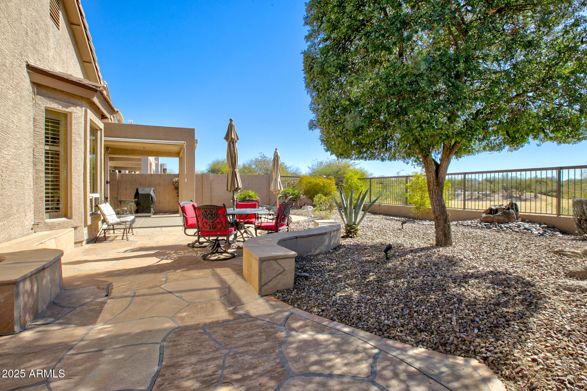 3055 North Red Mountain, Unit 156 Mesa, AZ 85207 - Photo 27 of 33 a view of a patio with table and chairs potted plants and large tree