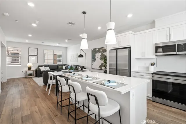 a large kitchen with a table and chairs