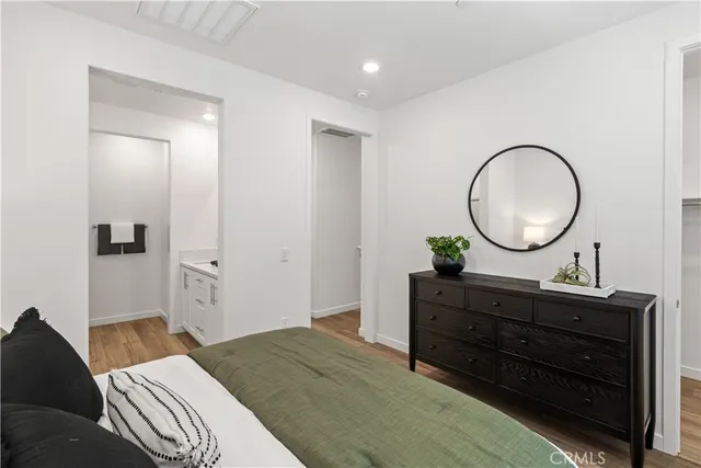 a bedroom with a bed and a mirror