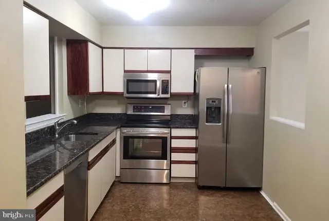 a kitchen with a refrigerator stove and sink