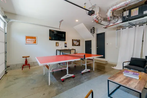 a room with furniture and air hockey table