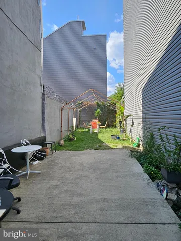 a view of a patio with table and chairs and potted plants