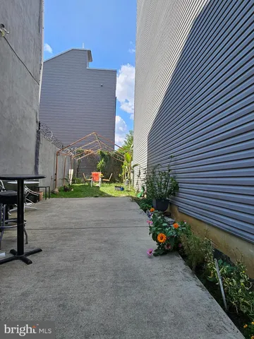 a view of a street with potted plants