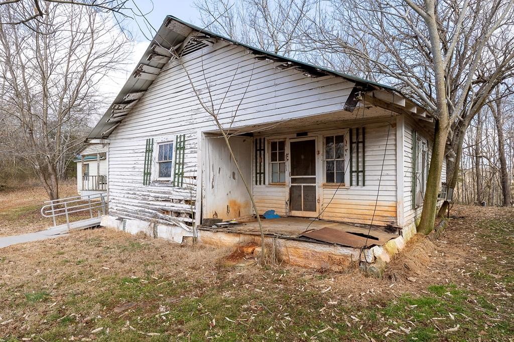 786 Quebeck Road Quebeck, TN 38579 - Photo 21 of 30 a backyard of a house with large trees and outdoor seating