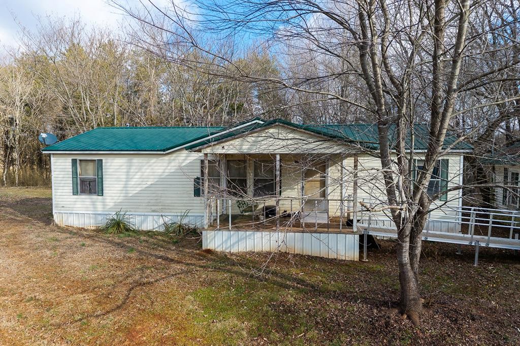 786 Quebeck Road Quebeck, TN 38579 - Photo 5 of 30 a backyard of a house with table and chairs under an umbrella