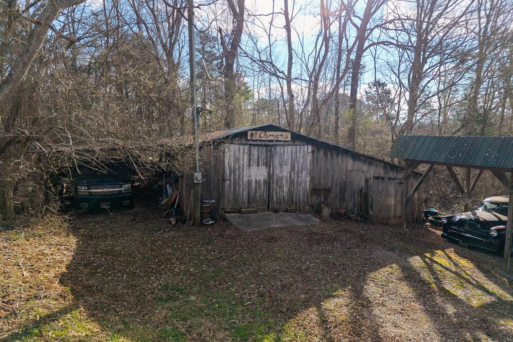 786 Quebeck Road Quebeck, TN 38579 - Photo 7 of 30 a backyard of a house with lots of green space and trees