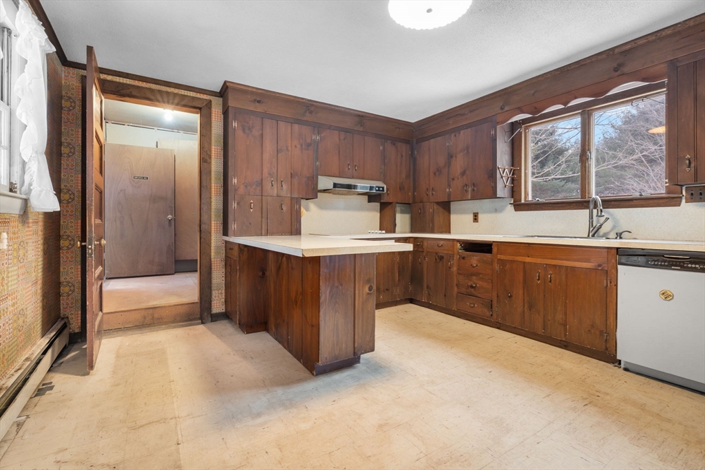 169 Nashua Road Pepperell, MA 01463 - Photo 14 of 31 a kitchen with a sink a stove and cabinets