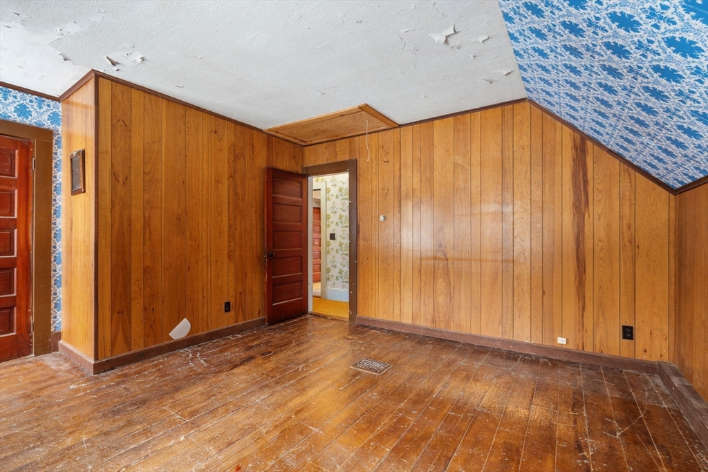 169 Nashua Road Pepperell, MA 01463 - Photo 22 of 31 a view of an empty room with wooden walls