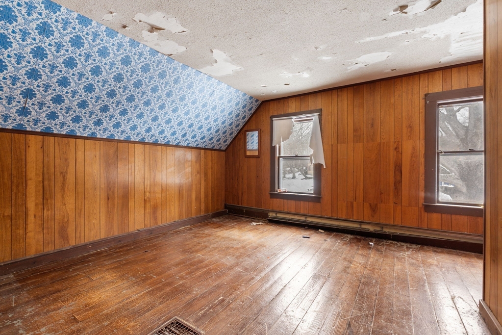 169 Nashua Road Pepperell, MA 01463 - Photo 24 of 31 an empty room with wooden floor and windows