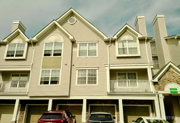 a front view of a residential apartment building with a yard