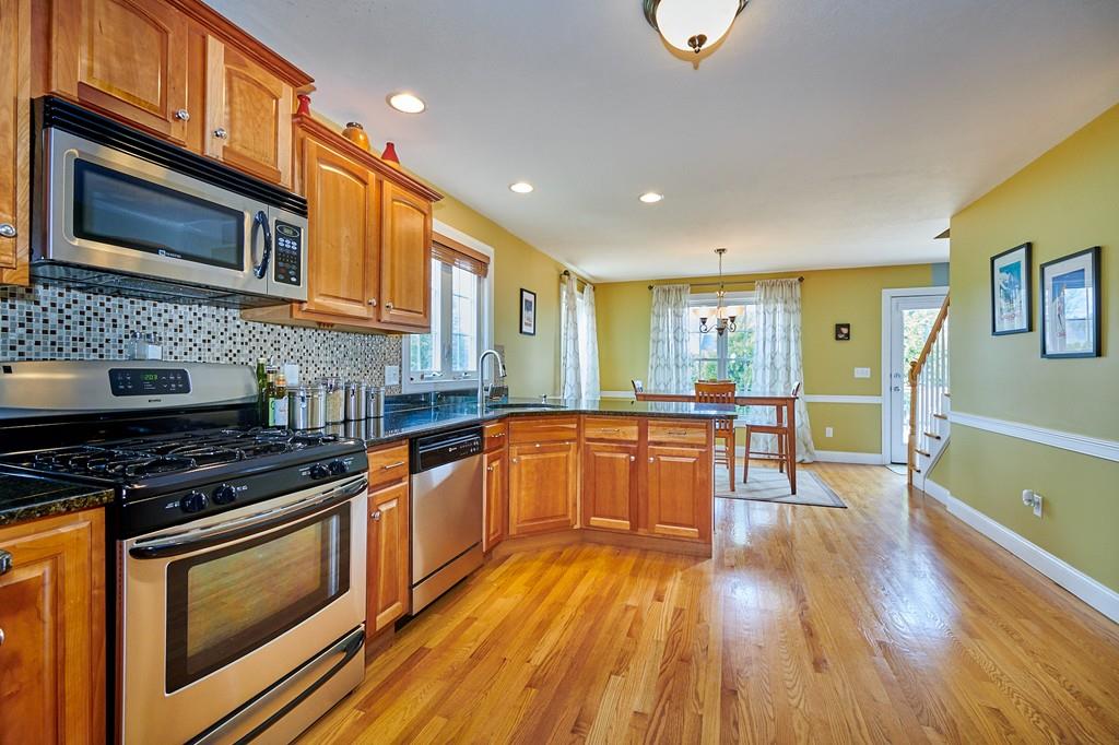 119 White Loaf Road Southampton, MA 01073 - Photo 7 of 41 a kitchen with stainless steel appliances wooden floors wooden cabinets and sink