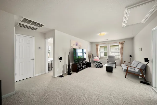 a view of a livingroom with furniture and a flat screen tv