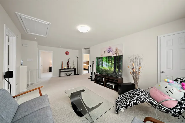 a bedroom with furniture and a flat screen tv