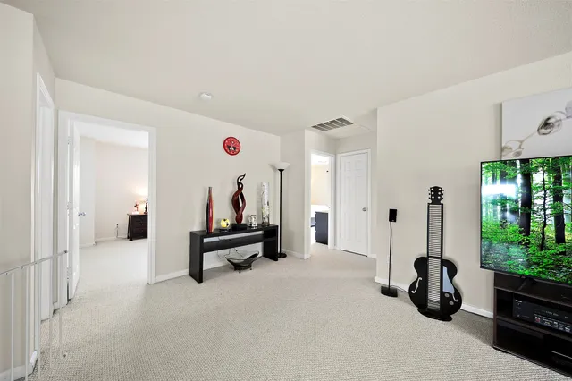 a living room with furniture gym equipment and a large window