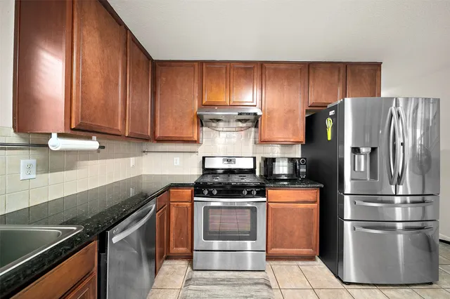 a kitchen with a stove microwave and refrigerator