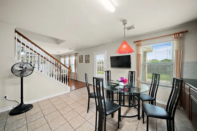 a dining room with furniture wooden floor and a chandelier