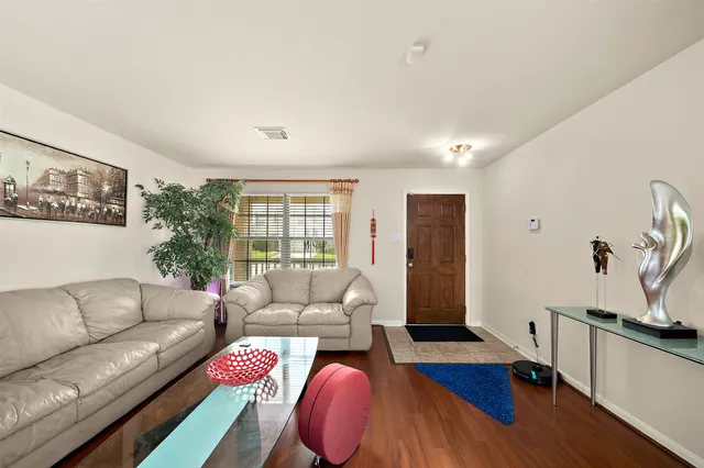 a living room with furniture and wooden floor