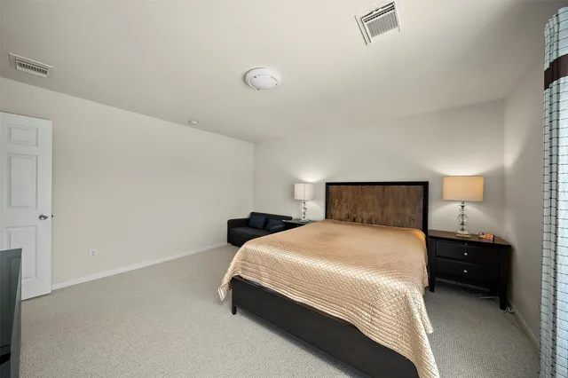 a bedroom with a bed and a lamp