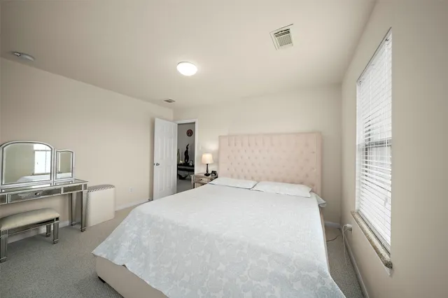 a large white bed in a white room