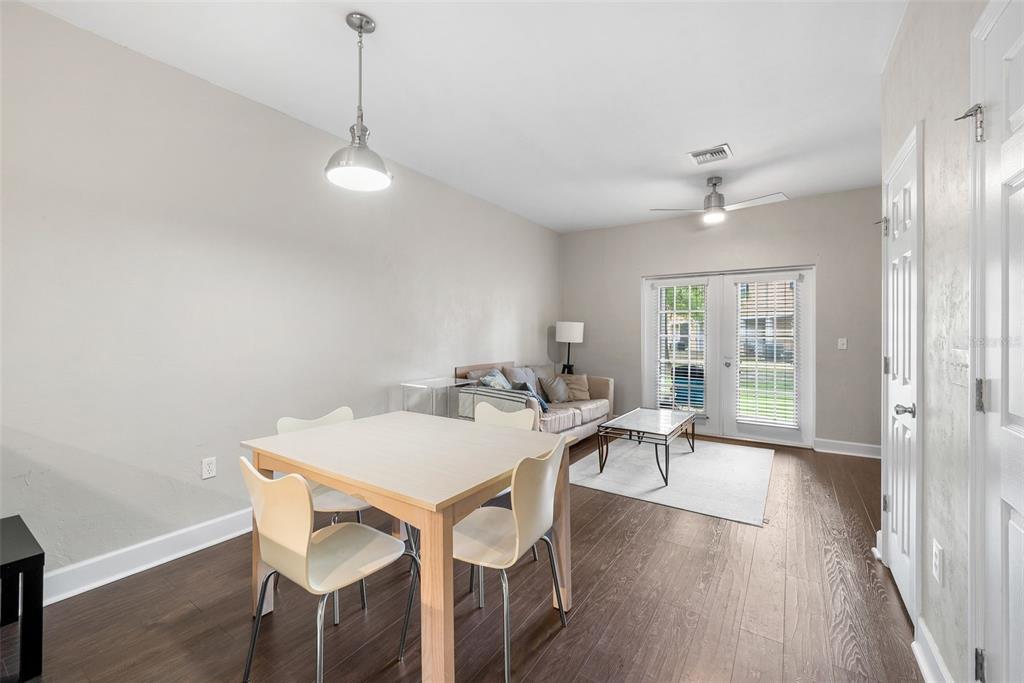 2927 Southwest 35th Place, Unit 113 Gainesville, FL 32608 - Photo 12 of 27 a view of a dining room with furniture window and wooden floor