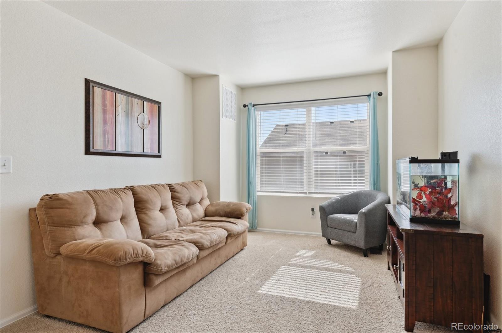 2328 Ruby Avenue Brighton, CO 80603 - Photo 11 of 21 a living room with furniture and a window