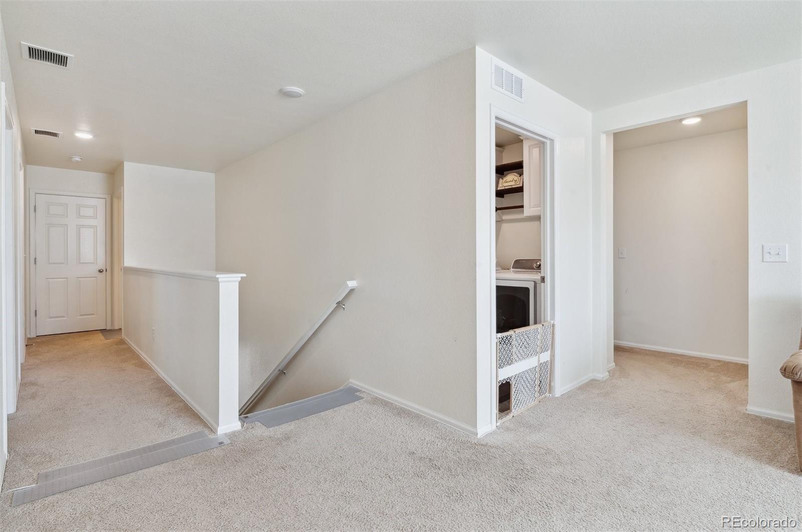 2328 Ruby Avenue Brighton, CO 80603 - Photo 12 of 21 wooden floor in an empty room with a kitchen
