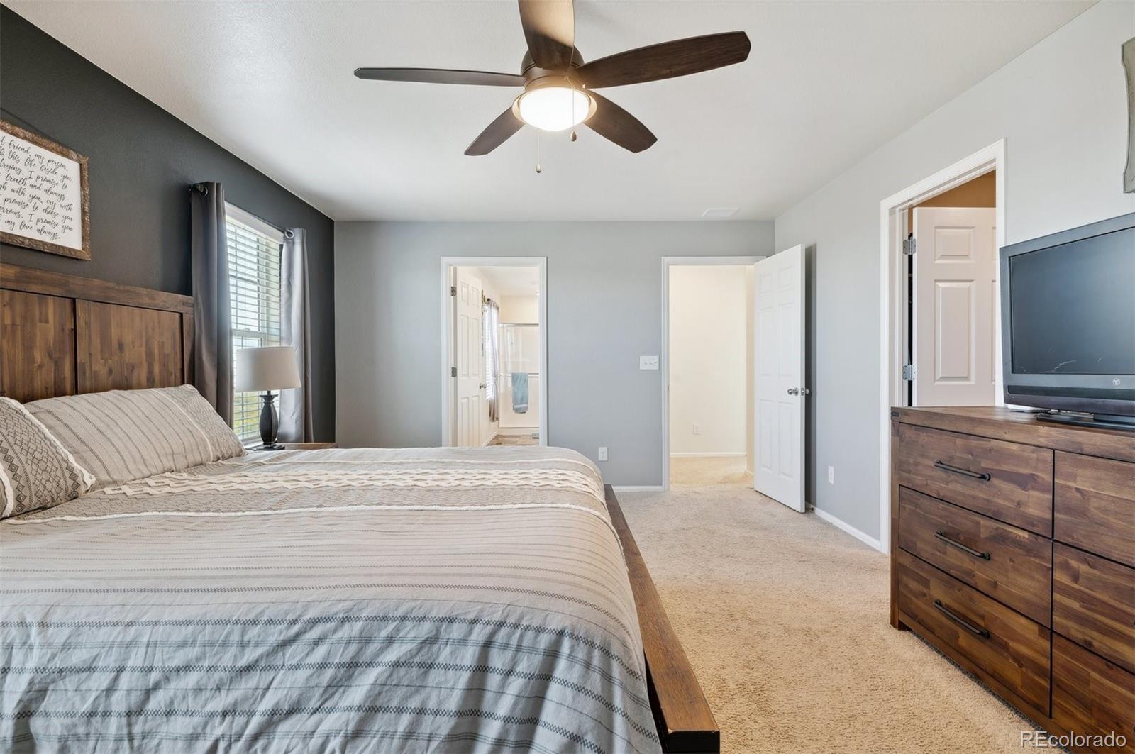 2328 Ruby Avenue Brighton, CO 80603 - Photo 14 of 21 a bedroom with a bed and a flat screen tv